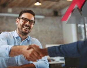 Smiling man shaking hands in office.