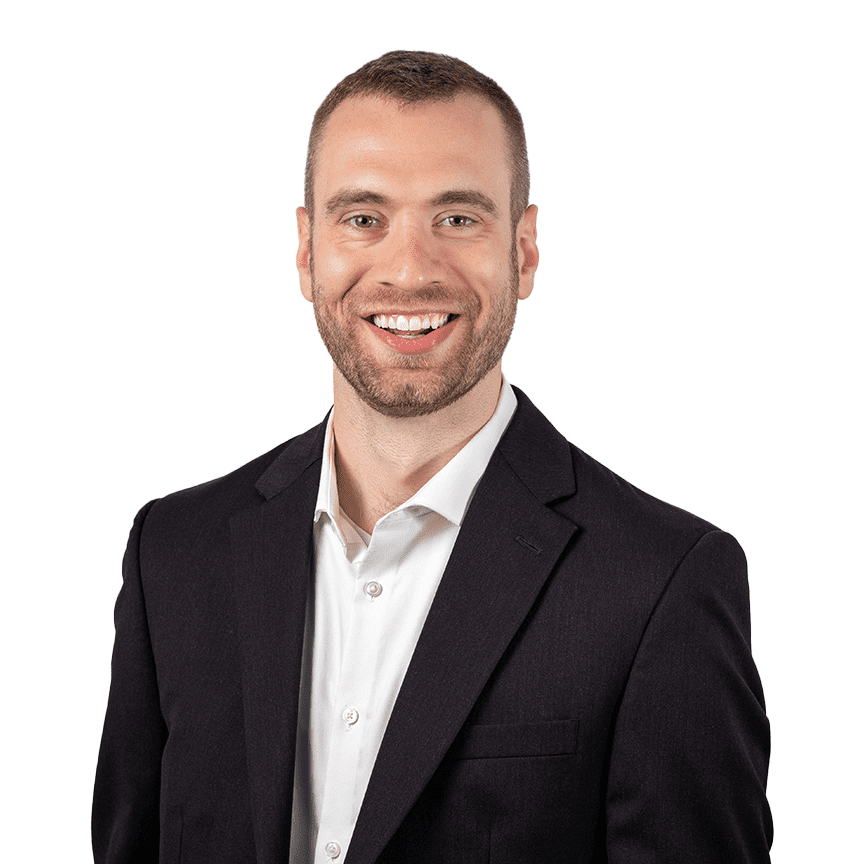 Smiling man in a suit and white shirt.